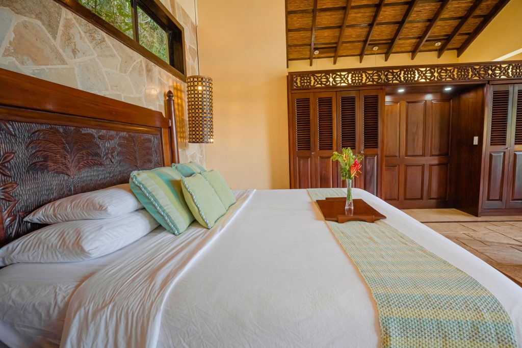 The king sized bed with pillows and linen inside the Mountain View Penthouse at The Rainforest Lodge at Sleeping Giant