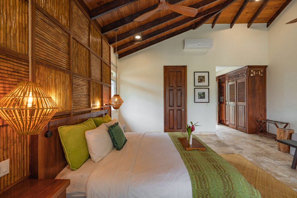 The master bedroom with a king sized bed inside of the Riverview Suite with Plunge Pool at The Rainforest Lodge at Sleeping Giant