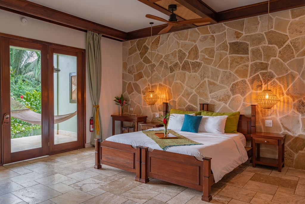 The king sized bed inside the riverside rooms at The Rainforest Lodge at Sleeping Giant