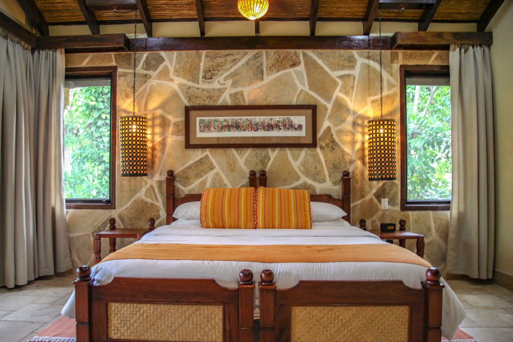 The king sized bed with pillows and linen inside of the Riverview Room at The Rainforest Lodge at Sleeping Giant