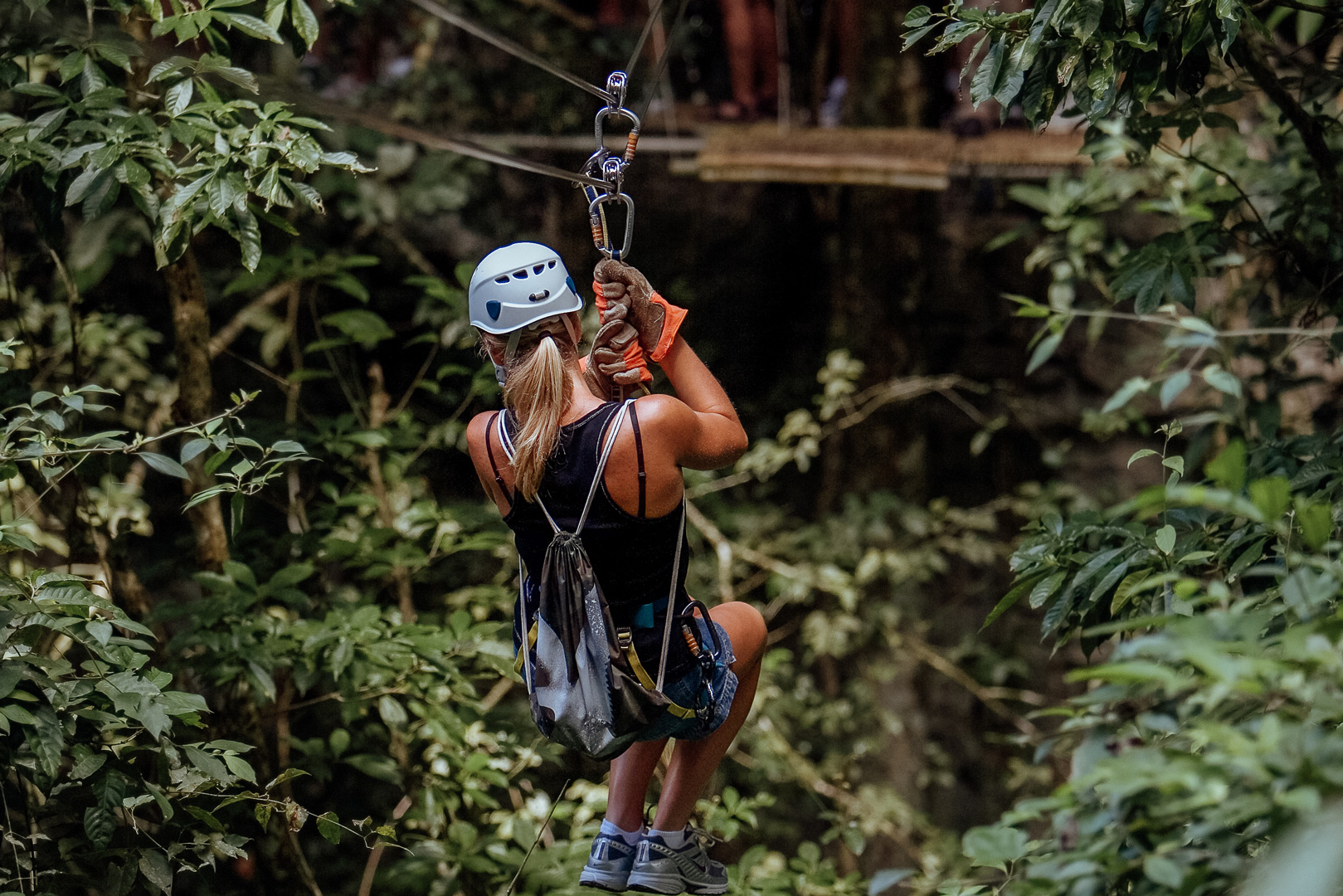 A woman ziplining during the Angel Fall Extreme Ziplining tour at The Rainforest Lodge at Sleeping Giant