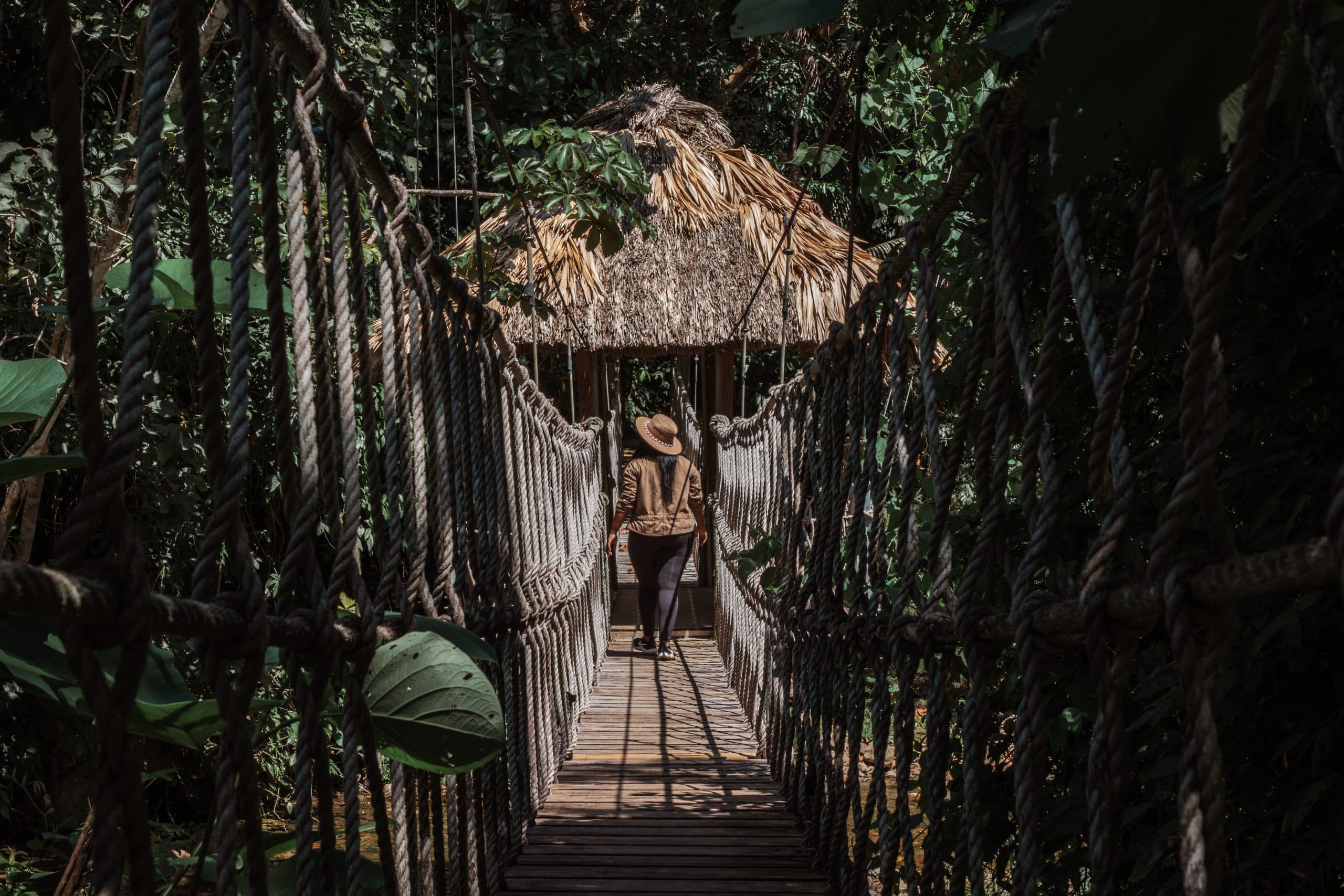 A guest walking on the rope bridge at the Rainforest Lodge at Sleeping Giant Resort