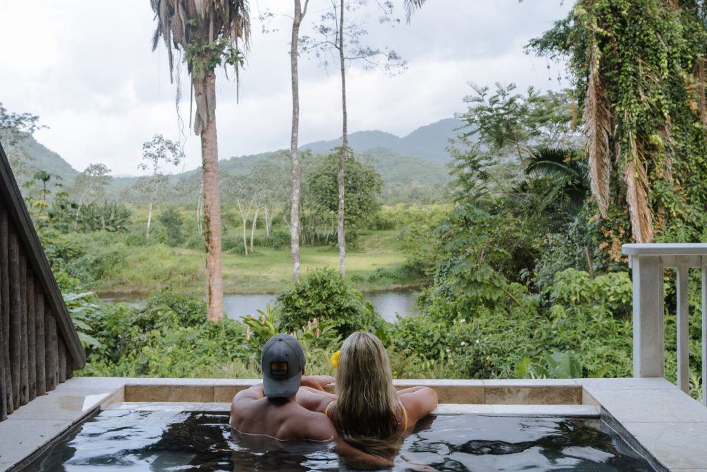 A couple taking a dip in the plunge pool outside their room at The Rainforest Lodge at Sleeping Giant