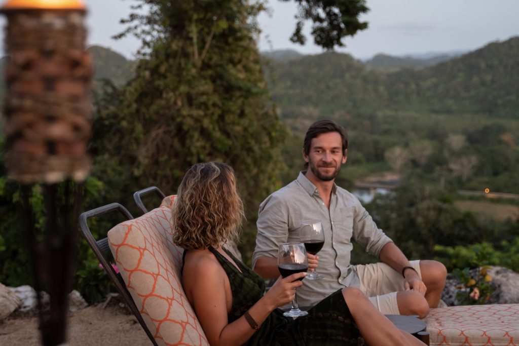 A couple sharing a glass of wine at The Rainforest Lodge at Sleeping Giant