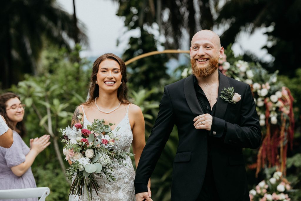 A married couple holding hands at the rainforest lodge at sleeping giant resort