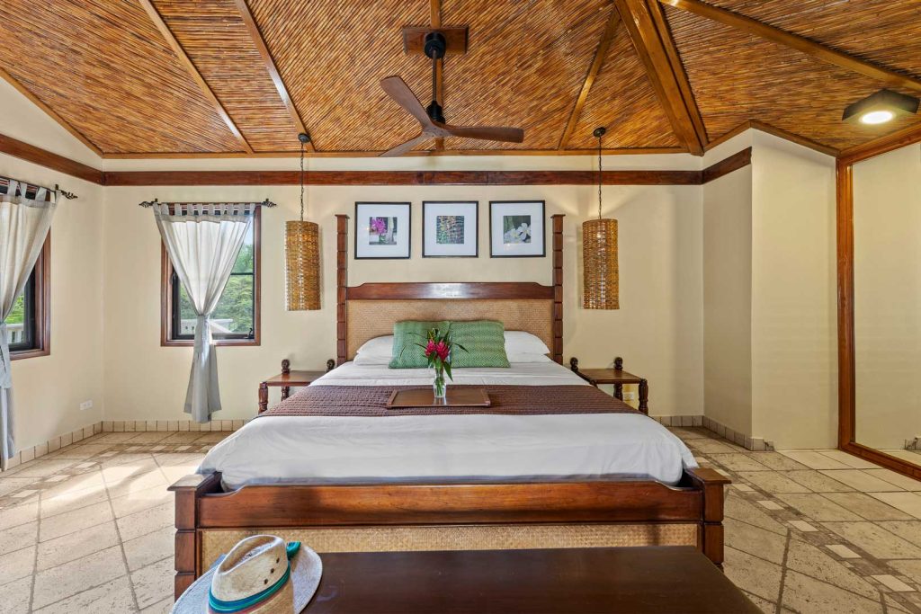 The king sized bed inside the Jungle Cottage with Plunge Pool at The Rainforest Lodge at Sleeping Giant