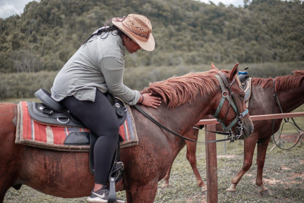 A guest riding a horse at The Sleeping Giant Horseback Riding Adventure