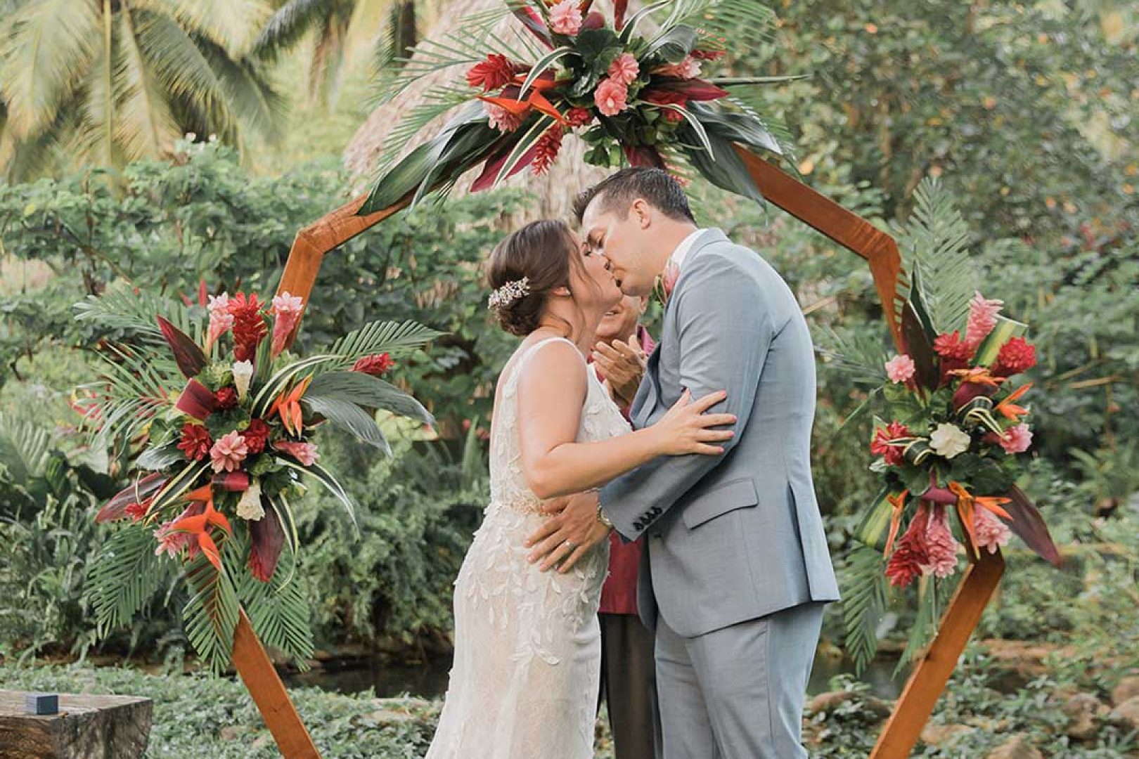 A couple, who is getting married, sharing a kiss at the altar.