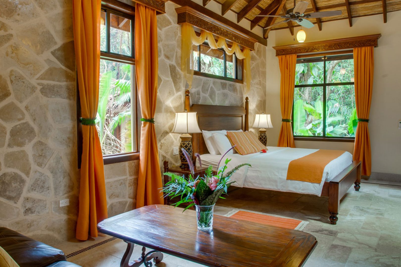 A table and bed inside the Creekside Cottages at The Rainforest Lodge at Sleeping Giant Resort