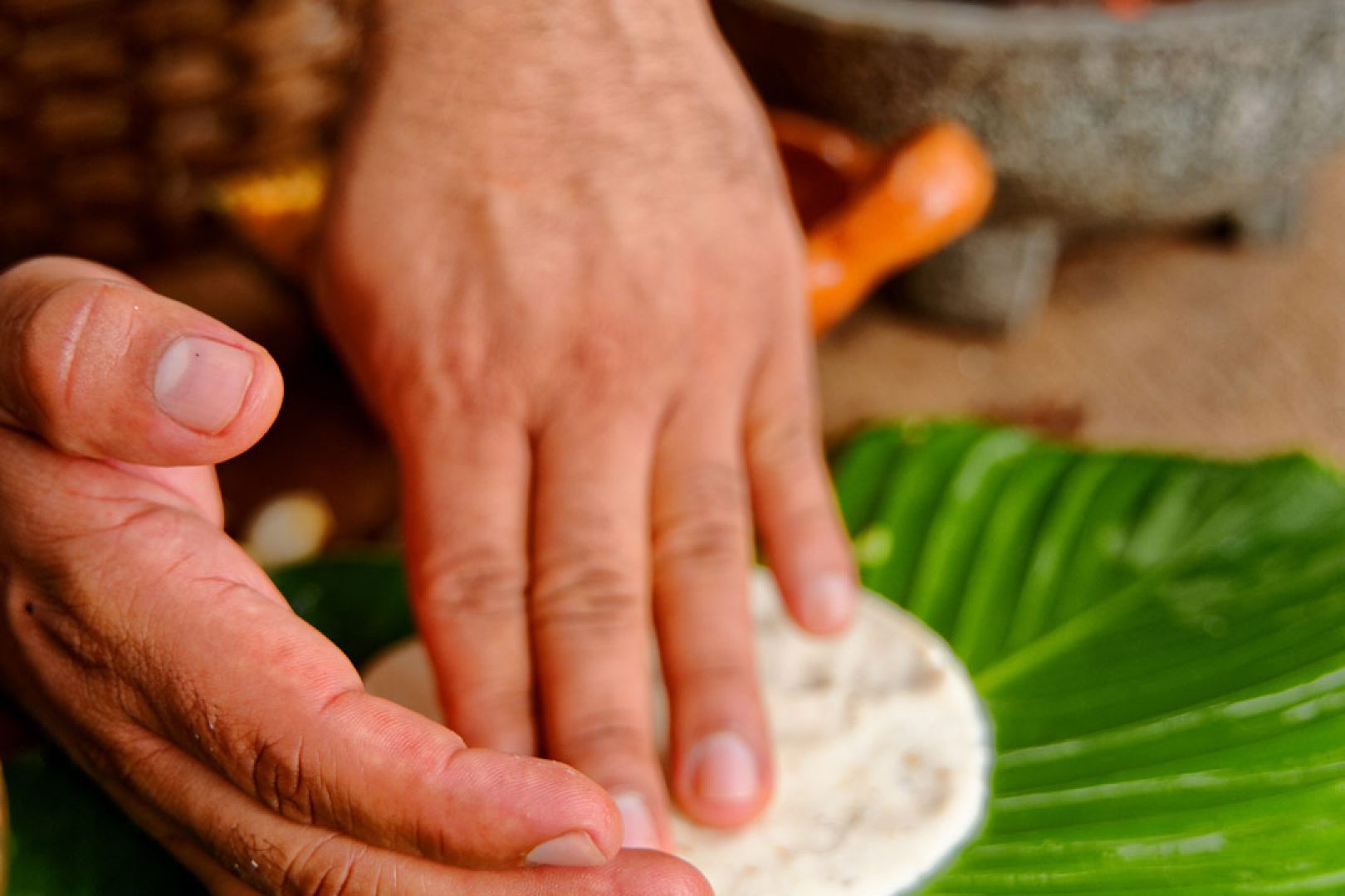 A homemade tortilla being pressed by hand during the Maya cooking class at The Rainforest Lodge at Sleeping Giant