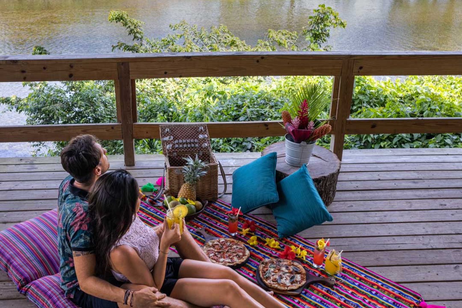 A couple having a picnic on the yoga deck in the jungle at The Rainforest Lodge at Sleeping Giant