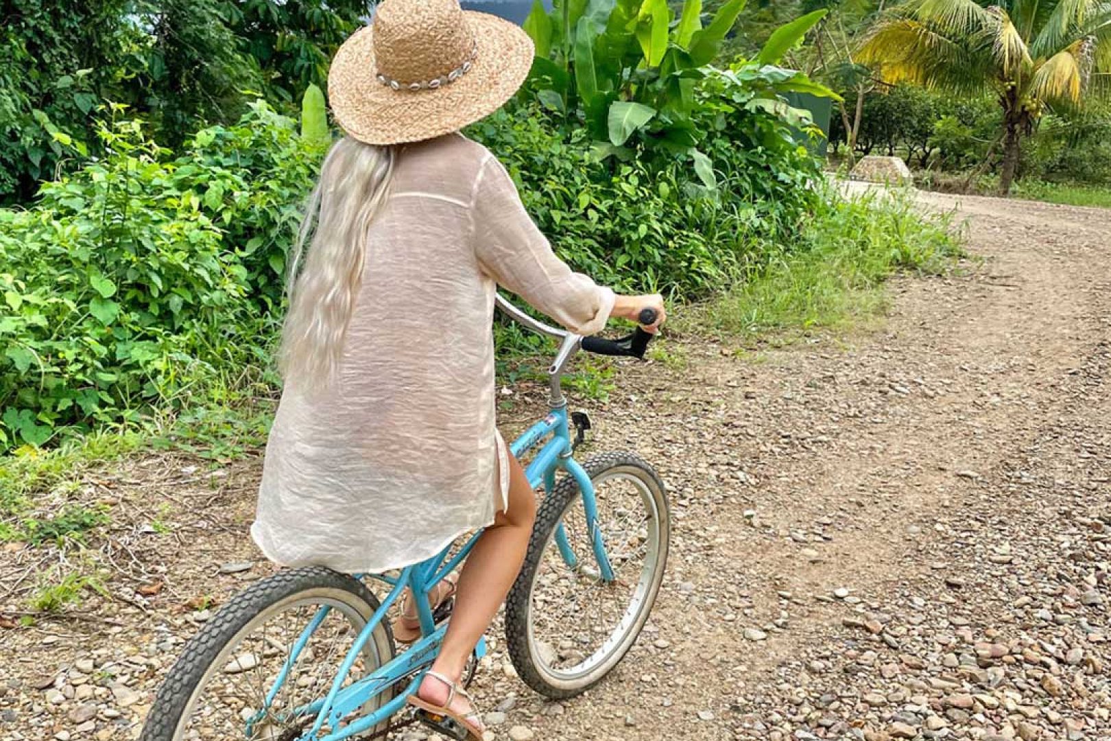 A guest riding a bike on the trails at The Rainforest Lodge at Sleeping Giant Resort