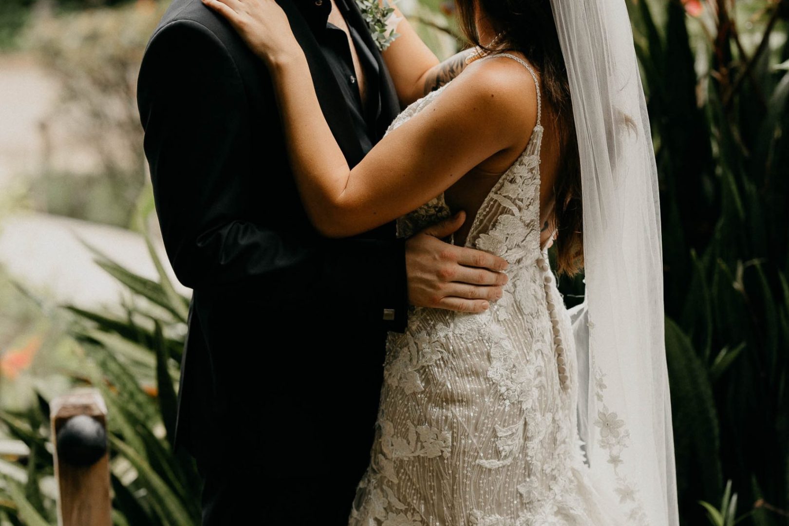 A married couple smiling and looking at each other at The Rainforest Lodge at Sleeping Giant